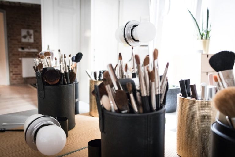 Makeup brushes and beauty products arranged on a vanity