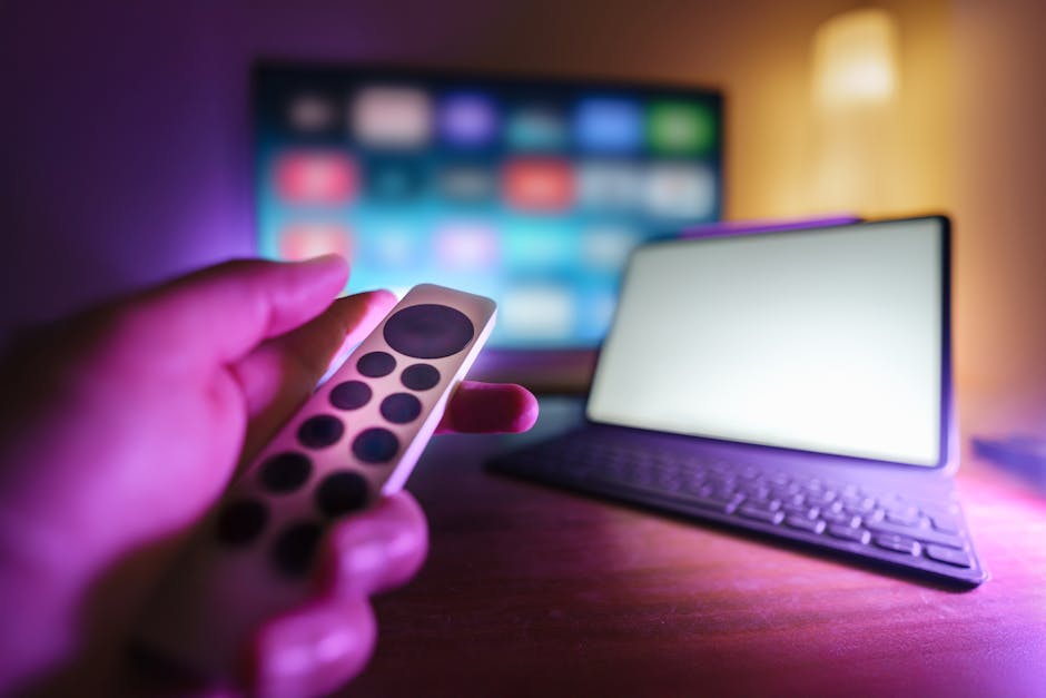 Remote control aimed at a TV in a cozy streaming setup