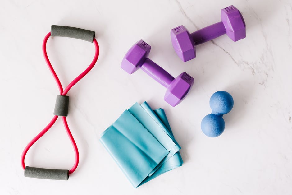 Dumbbells and resistance bands laid out for a workout