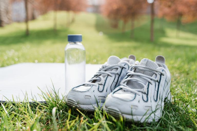 Running shoes and a water bottle ready for an outdoor workout