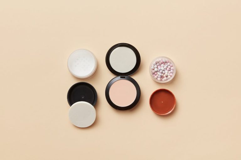 Unbranded makeup containers arranged on a neutral surface