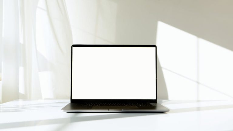 Minimal laptop with a blank screen on a bright workspace table